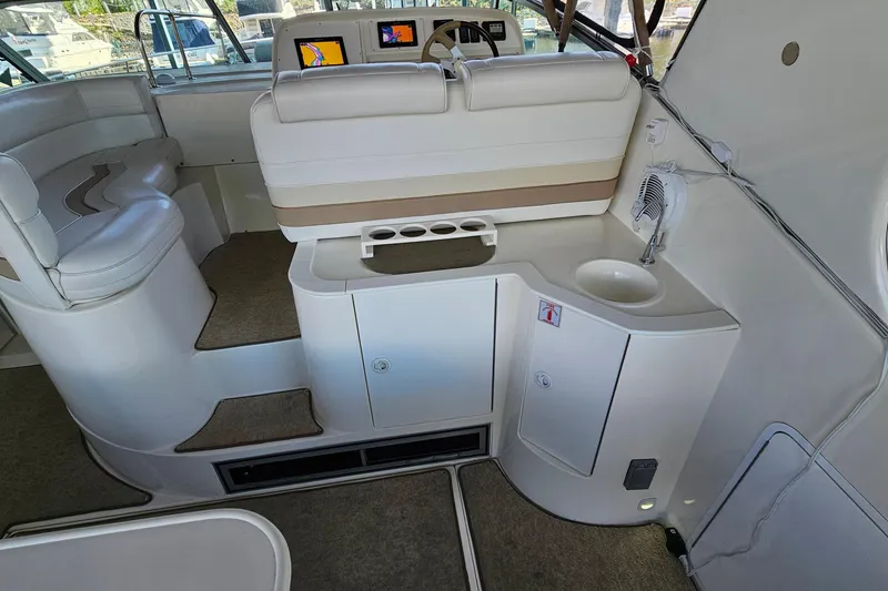 Slide: The Image of Interior of 1996 Cruisers Yachts 3570 Esprit with seating, sink, and helm controls. - 9