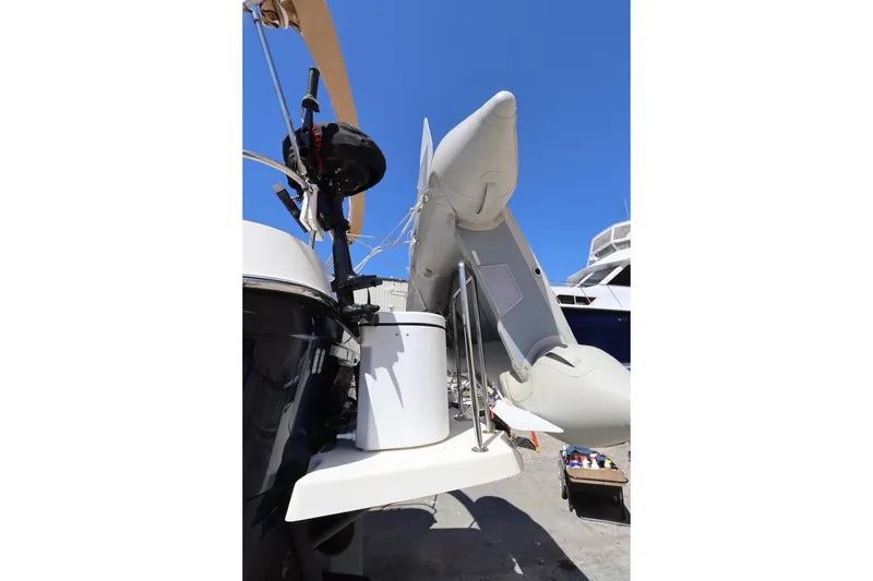 Slide: The Image of 2015 Ranger Tugs R-27 with inflatable dinghy on deck under clear blue sky. - 13