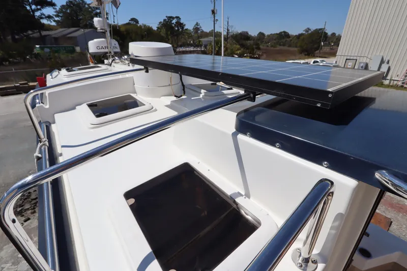Slide: The Image of 2015 Ranger Tugs R-27 boat with solar panel and railing on deck. - 24