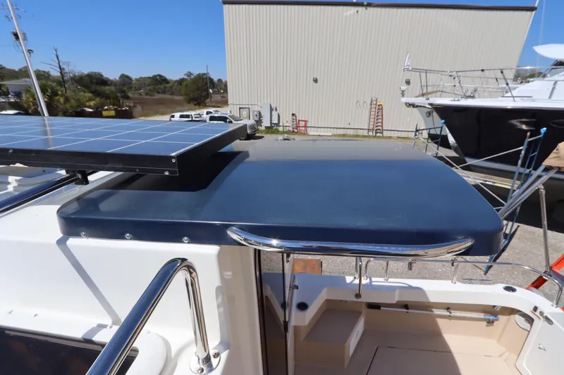 Slide: The Image of 2015 Ranger Tugs R-27 boat with solar panel on deck, docked outdoors. - 25