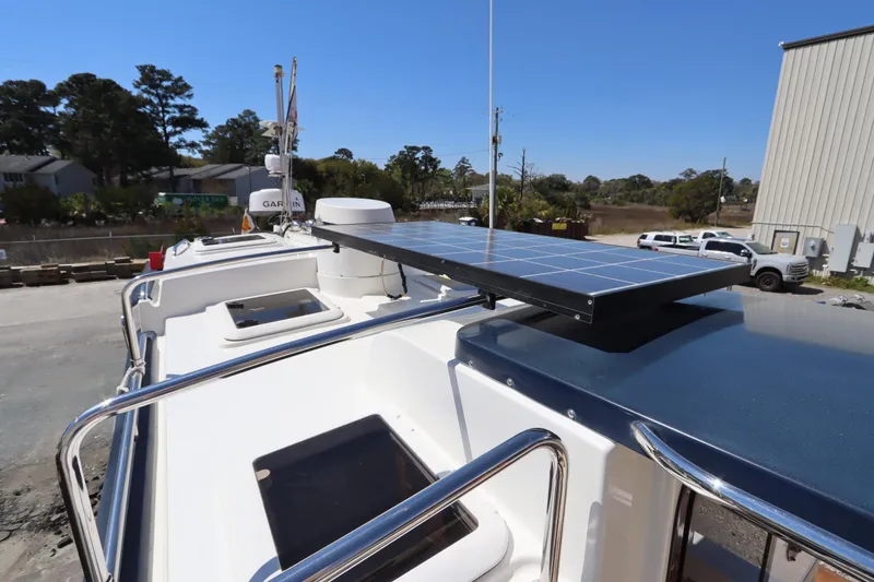 Slide: The Image of 2015 Ranger Tugs R-27 boat with solar panel on deck, parked outdoors. - 26