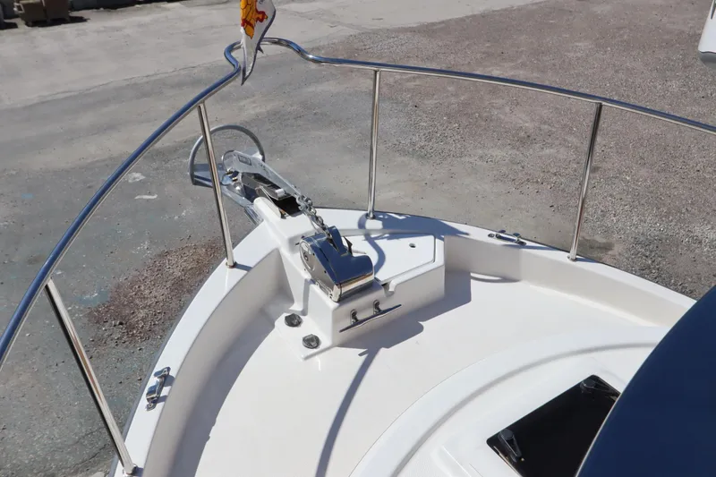 Slide: The Image of 2015 Ranger Tugs R-27 boat bow with anchor and railing in a marina setting. - 29