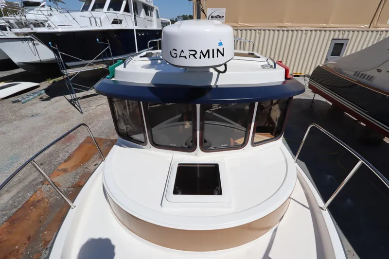 Slide: The Image of 2015 Ranger Tugs R-27 boat with Garmin radar, docked in a marina. - 33