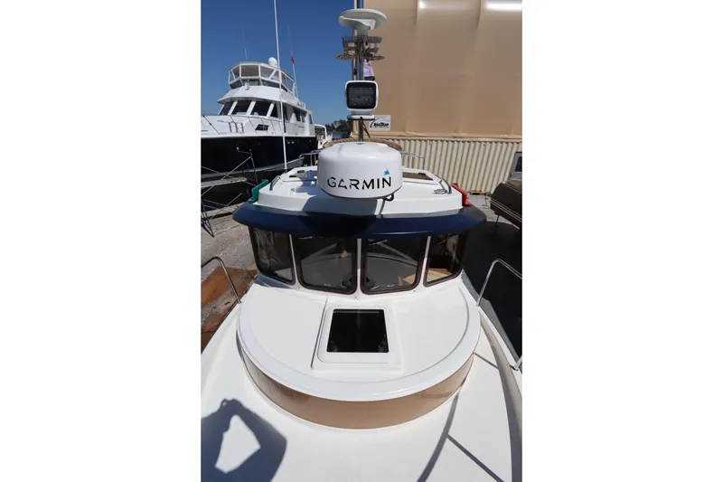 Slide: The Image of 2015 Ranger Tugs R-27 boat with Garmin navigation equipment, docked in a marina. - 34
