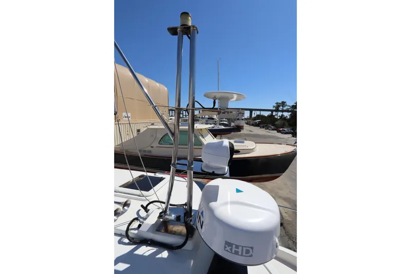 Slide: The Image of 2015 Ranger Tugs R-27 boat with radar equipment, docked under clear blue sky. - 38