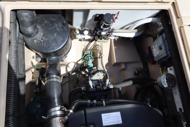 Slide: The Image of Engine compartment of a 2015 Ranger Tugs R-27 boat, showing various mechanical components. - 41