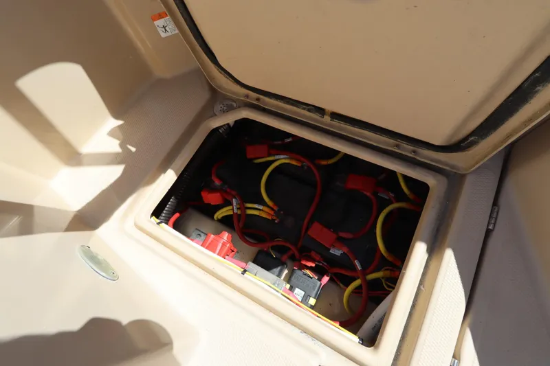 Slide: The Image of 2015 Ranger Tugs R-27 boat battery compartment with wiring and connections. - 45