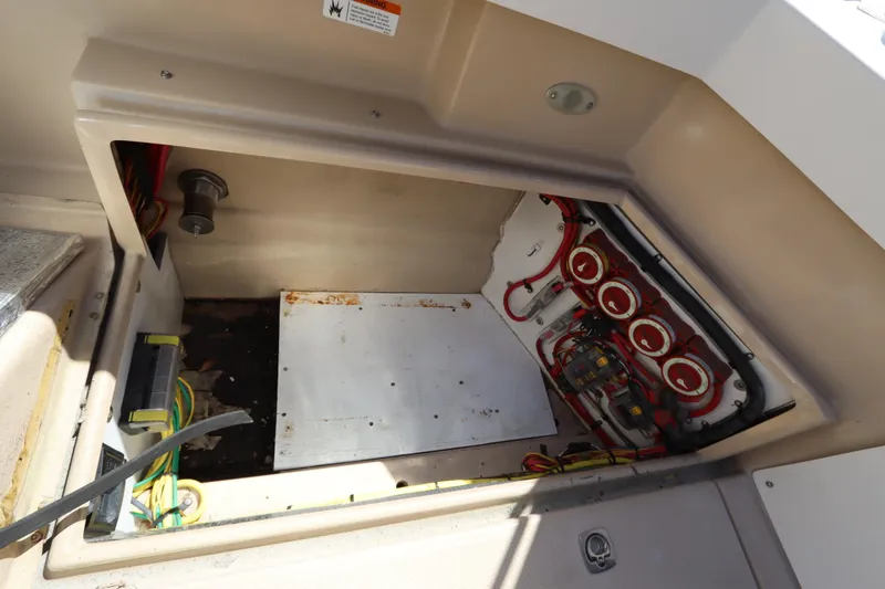 Slide: The Image of 2015 Ranger Tugs R-27 boat compartment with wiring and electrical components. - 46