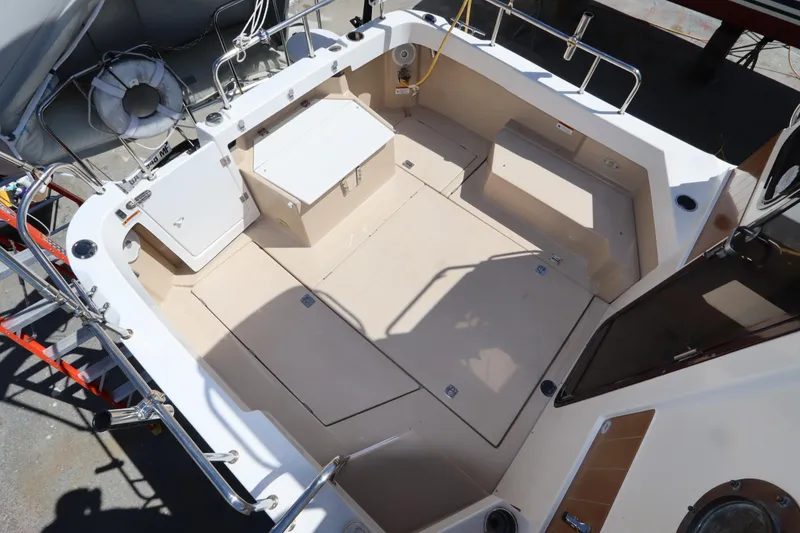 Slide: The Image of 2015 Ranger Tugs R-27 boat deck with seating and storage compartments. - 48