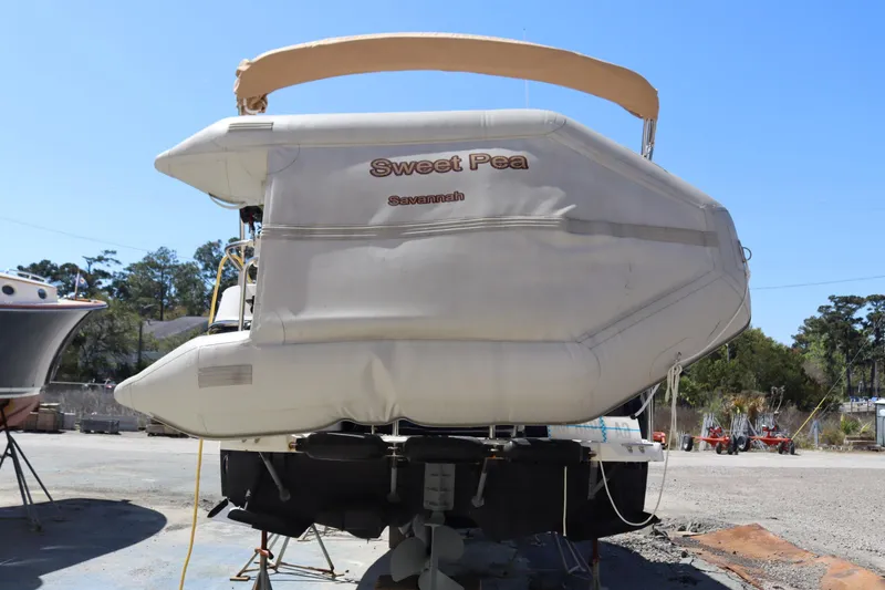 Slide: The Image of 2015 Ranger Tugs R-27 boat named "Sweet Pea" on land, rear view. - 5