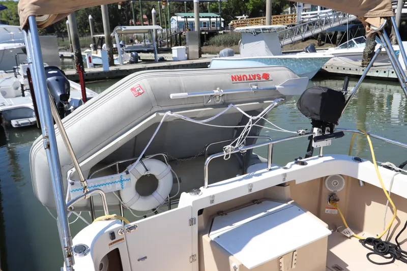 Slide: The Image of 2015 Ranger Tugs R-27 with dinghy and lifebuoy at marina dock. - 52