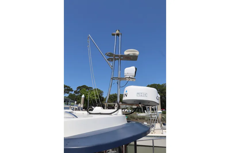 Slide: The Image of 2015 Ranger Tugs R-27 boat radar and antenna system under clear blue sky. - 56