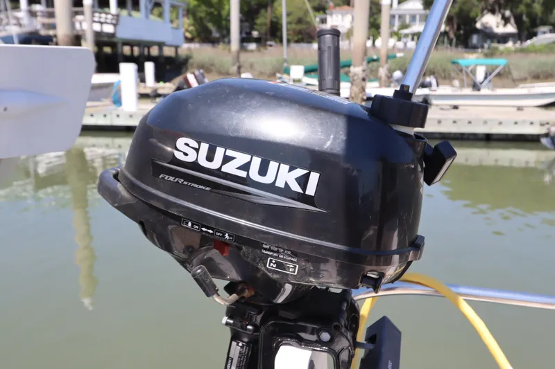Slide: The Image of Suzuki four-stroke outboard motor on a 2015 Ranger Tugs R-27 boat, dockside view. - 59