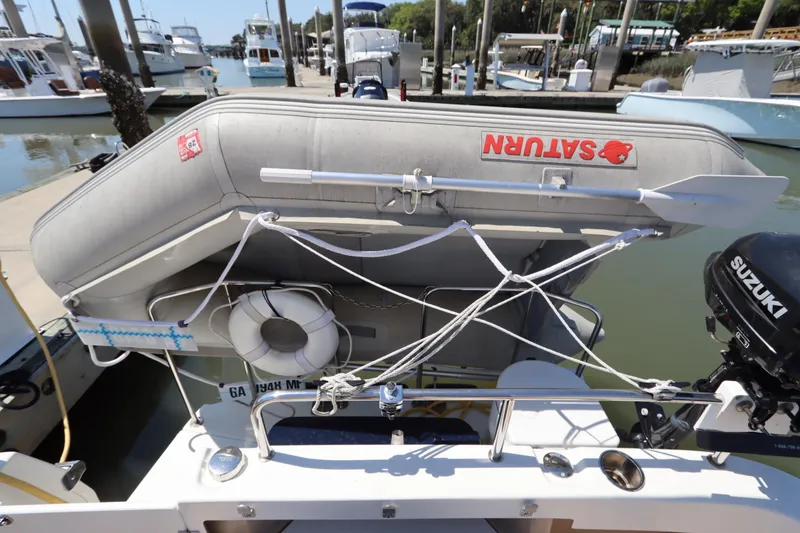 Slide: The Image of 2015 Ranger Tugs R-27 with inflatable dinghy and Suzuki outboard motor at marina. - 61