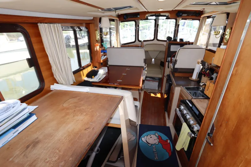 Slide: The Image of Interior of 2015 Ranger Tugs R-27 boat with wood finish and compact kitchen area. - 64