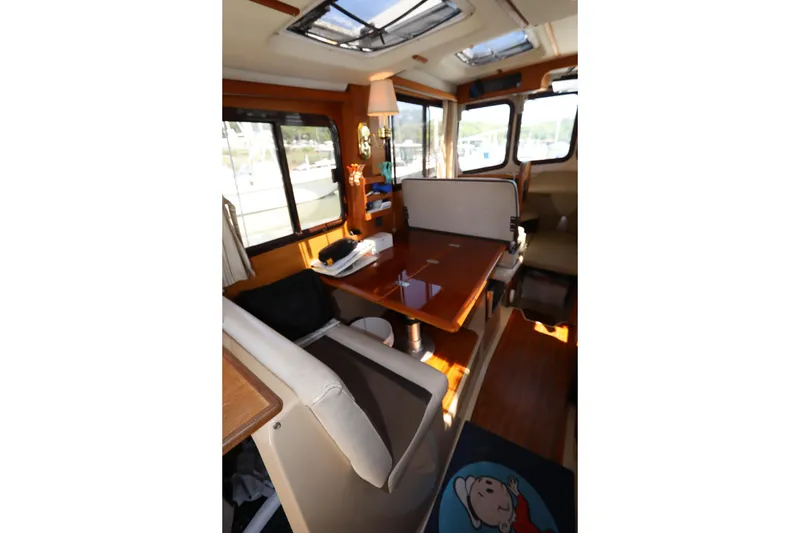 Slide: The Image of Interior of 2015 Ranger Tugs R-27 boat with dining area and windows. - 67