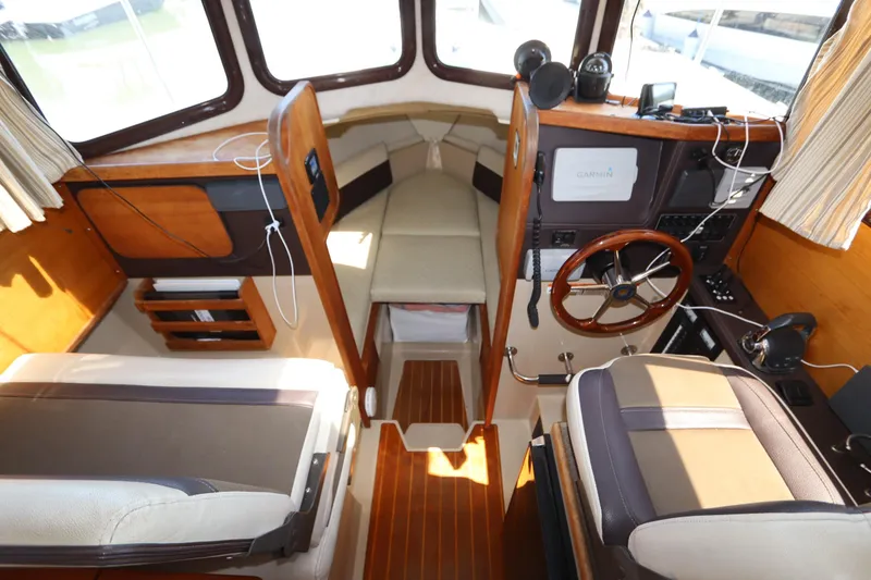 Slide: The Image of Interior of 2015 Ranger Tugs R-27 boat with helm, seating, and navigation equipment. - 68