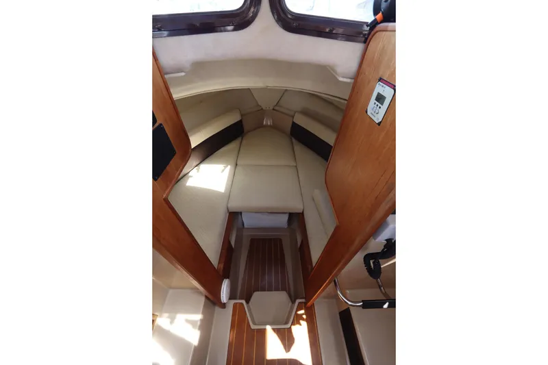 Slide: The Image of Interior cabin of 2015 Ranger Tugs R-27 boat with cozy seating and wooden accents. - 74