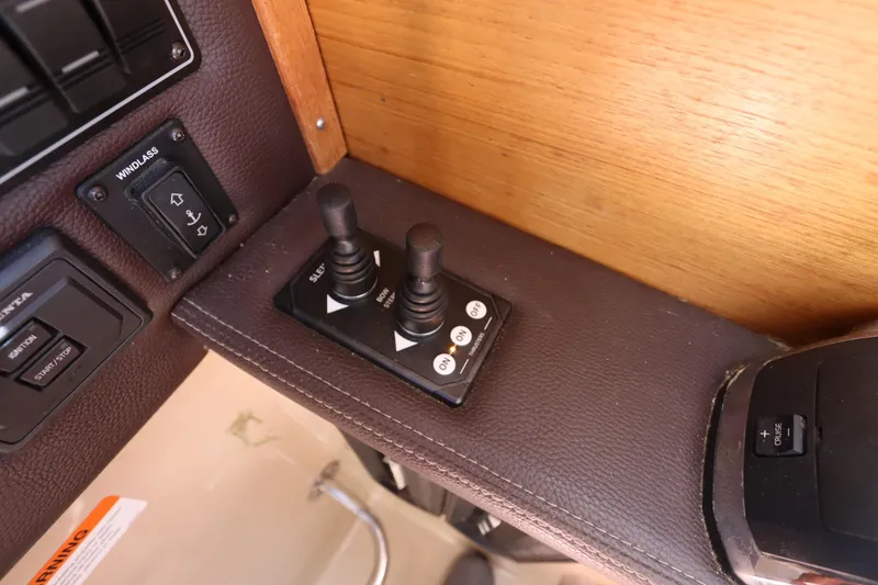 Slide: The Image of Control panel of a 2015 Ranger Tugs R-27 boat with joystick and switches. - 78