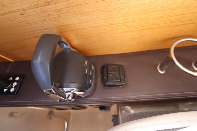 Slide: The Image of Control panel of a 2015 Ranger Tugs R-27 boat with throttle and switches. - 79