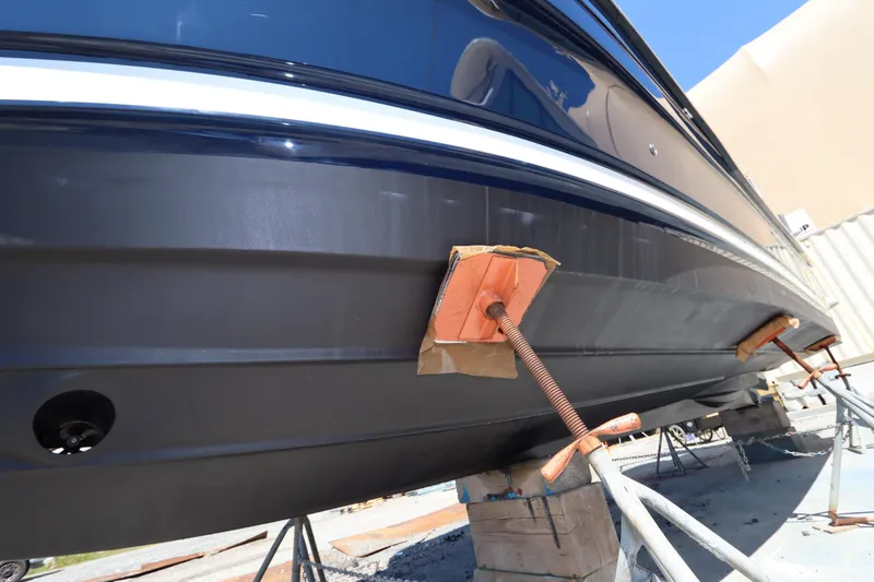 Slide: The Image of 2015 Ranger Tugs R-27 boat hull on supports, showcasing underside details. - 8