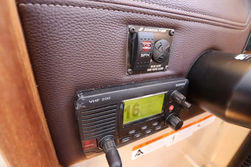 Slide: The Image of VHF radio and bilge alarm on 2015 Ranger Tugs R-27 boat dashboard. - 84