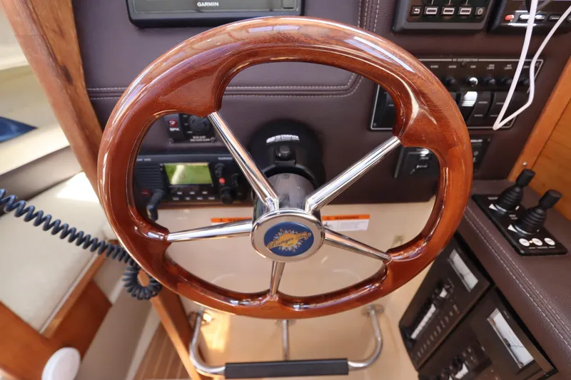 Slide: The Image of Steering wheel of a 2015 Ranger Tugs R-27 boat with control panel and instruments. - 86
