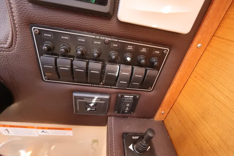Slide: The Image of Control panel of a 2015 Ranger Tugs R-27 boat with switches and labels. - 88