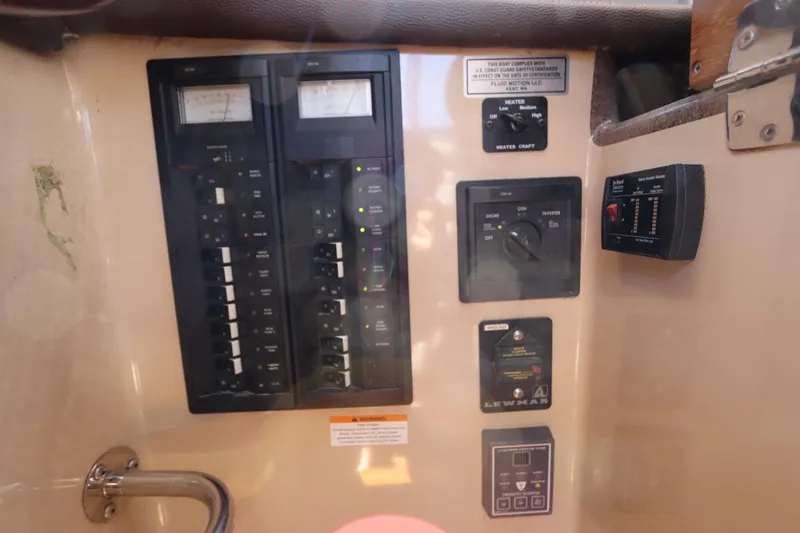 Slide: The Image of Electrical control panel on a 2015 Ranger Tugs R-27 boat interior. - 89