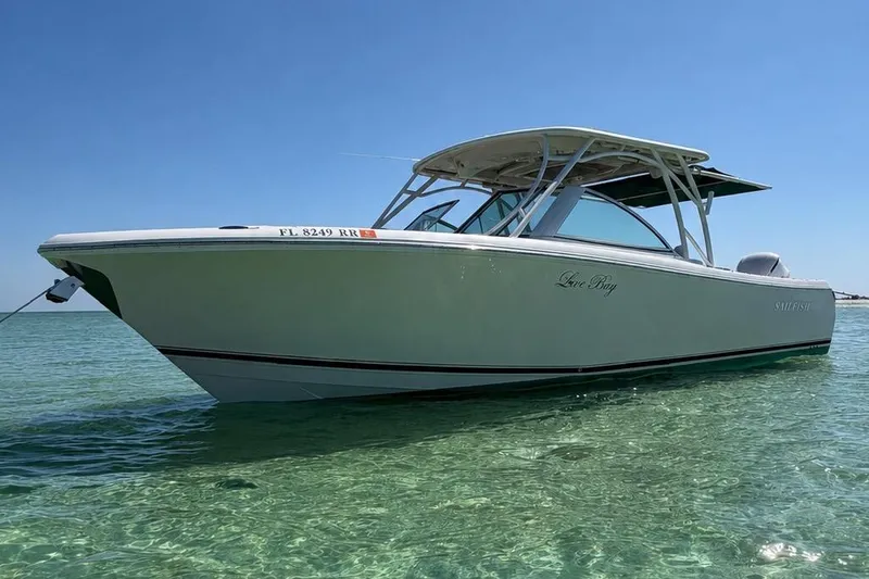 The Image of 2018 Sailfish 325 DC boat anchored in clear water. - 0