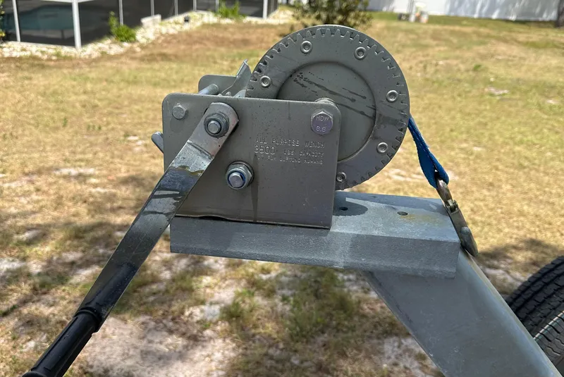 Slide: The Image of Boat trailer winch mechanism on a 2018 Sailfish 325 DC, parked on grass. - 24