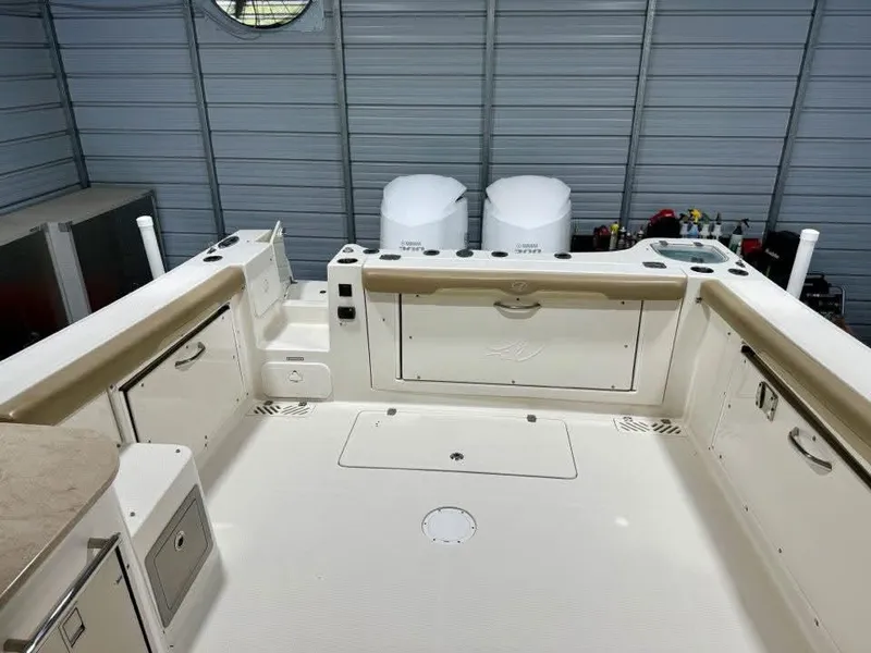 Slide: The Image of 2018 Sailfish 325 DC boat interior with dual engines in a storage facility. - 4