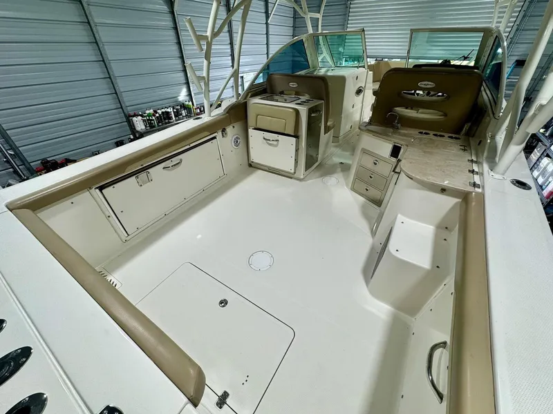 Slide: The Image of 2018 Sailfish 325 DC boat interior with spacious deck and storage compartments. - 5