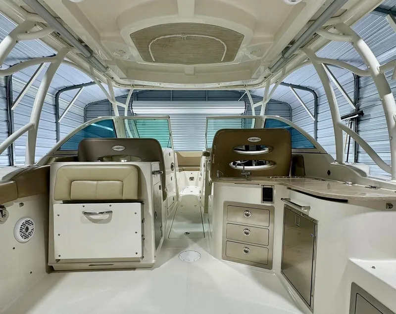 Slide: The Image of 2018 Sailfish 325 DC boat interior with seating, storage, and helm station. - 6