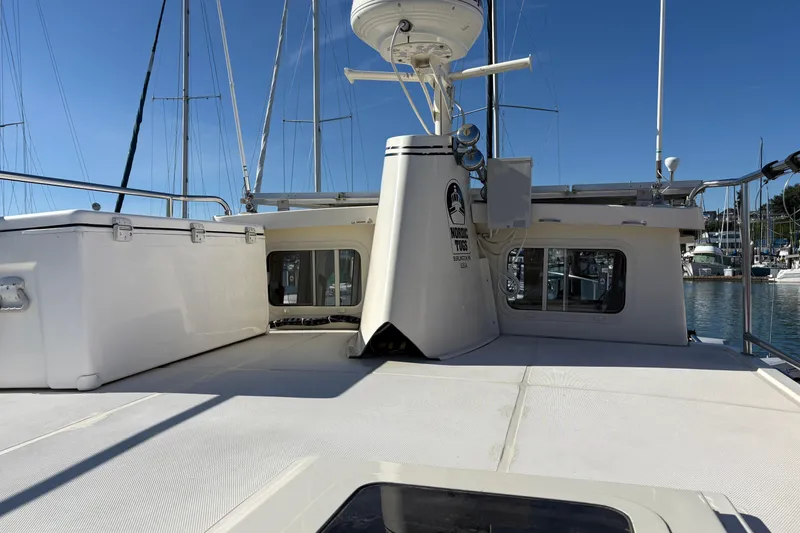 Slide: The Image of 2004 Nordic Tug 32 boat deck with clear sky and marina background. - 14