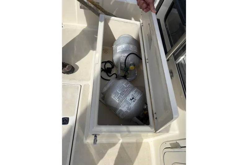 Slide: The Image of Open storage compartment on 2004 Nordic Tug 32 with propane tanks inside. - 15