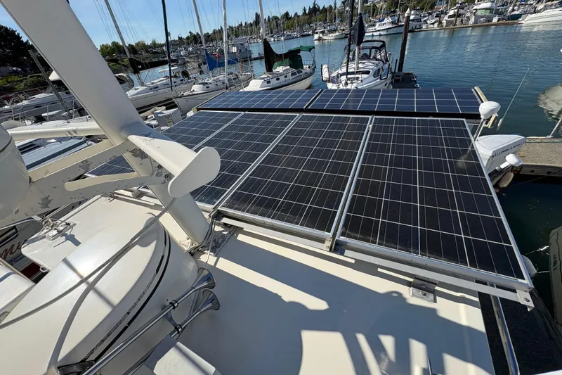 Slide: The Image of Solar panels on a 2004 Nordic Tug 32 boat docked at a marina. - 16