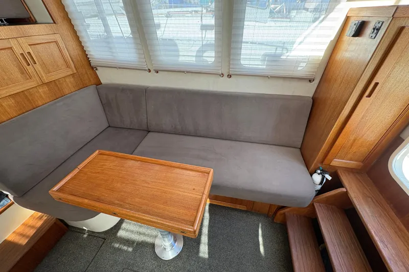 Slide: The Image of Interior of 2004 Nordic Tug 32 with cozy seating and wooden table. - 18