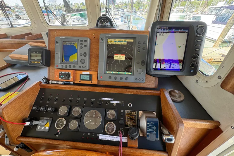 Slide: The Image of Control panel of a 2004 Nordic Tug 32 with navigation and monitoring equipment. - 26