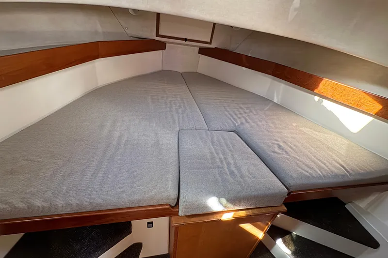 Slide: The Image of Cozy cabin interior of 2004 Nordic Tug 32 with cushioned sleeping area. - 32