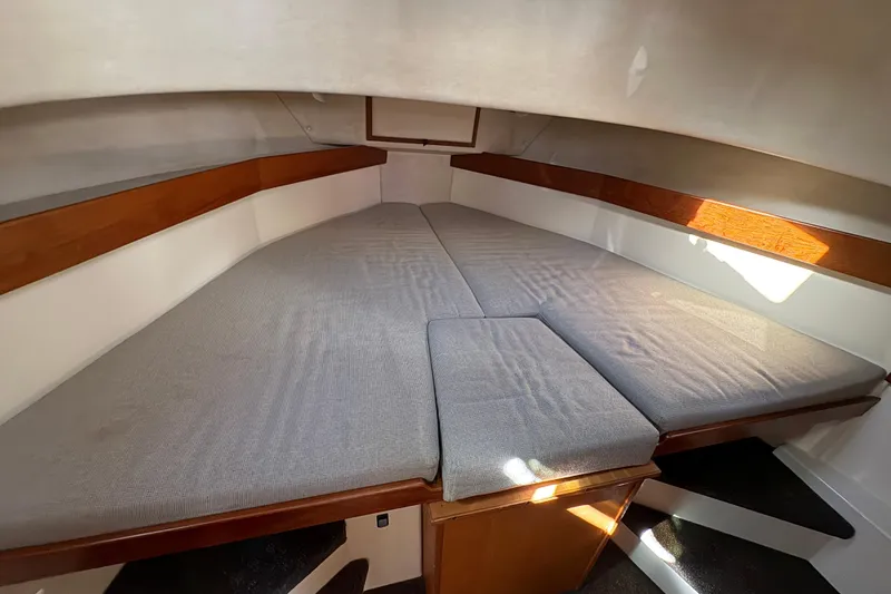 Slide: The Image of Cozy cabin interior of 2004 Nordic Tug 32 with cushioned V-berth. - 33