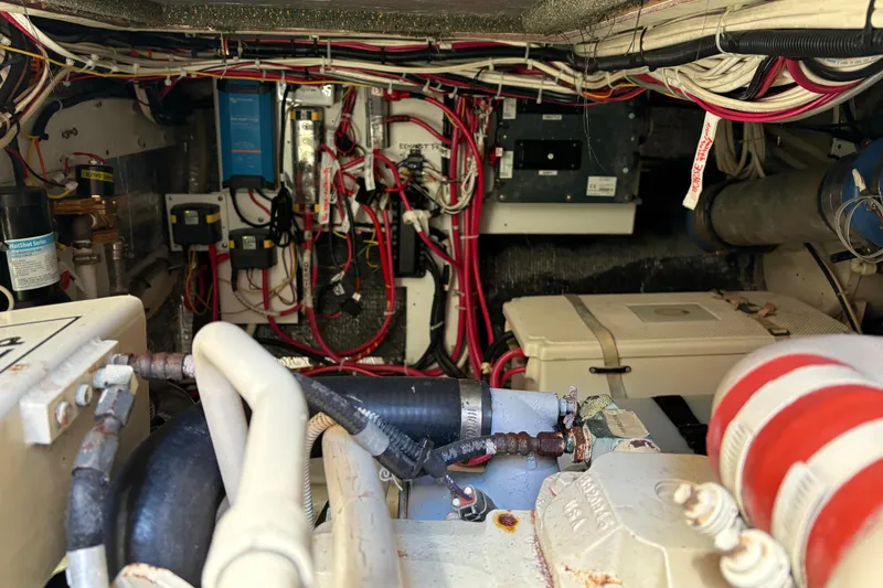 Slide: The Image of Engine room of a 2004 Nordic Tug 32, showcasing wiring and mechanical components. - 37