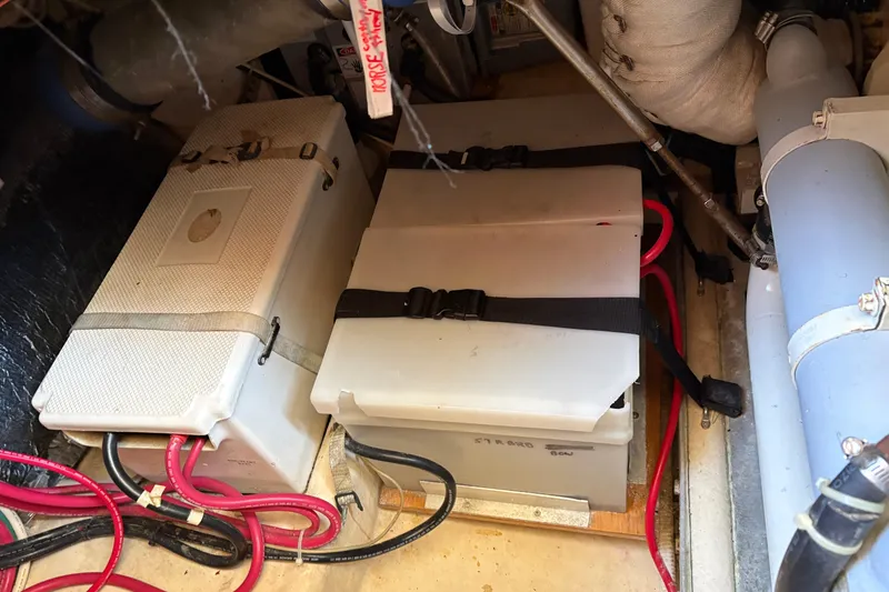 Slide: The Image of Battery compartment of a 2004 Nordic Tug 32 with secured cables and components. - 38
