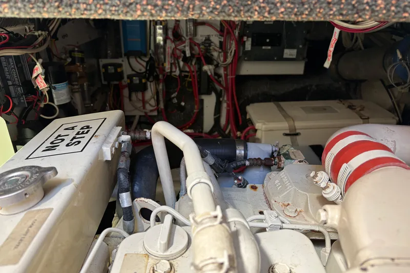 Slide: The Image of Engine room of a 2004 Nordic Tug 32, featuring complex wiring and components. - 42