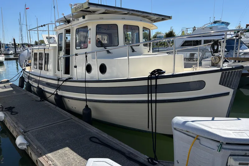 Slide: The Image of 2004 Nordic Tug 32 docked at marina, showcasing classic design and sturdy build. - 7