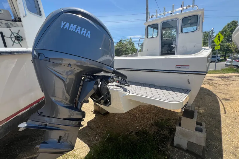 Slide: The Image of 2026 Defiance Admiral 220 EX boat with Yamaha outboard motor, parked on blocks. - 8
