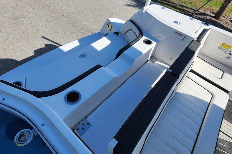 Slide: The Image of 2022 Yamaha 255 FSH Sport E boat interior with sleek seating and cup holders. - 10