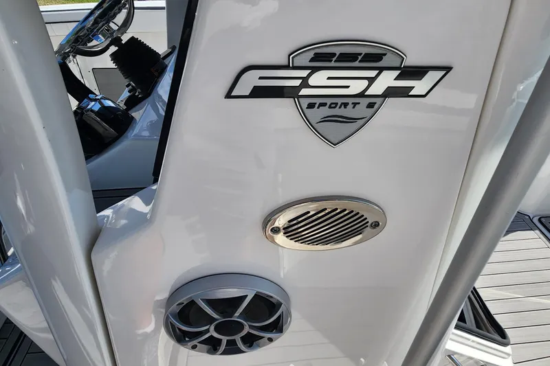 Slide: The Image of 2022 Yamaha 255 FSH Sport E boat console with logo and speaker detail. - 15