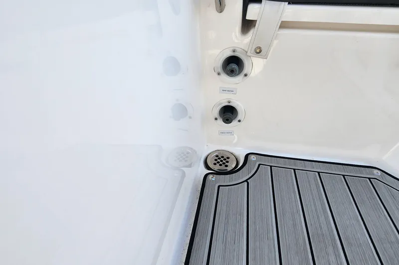 Slide: The Image of Yamaha 255 FSH Sport E 2022 boat deck with water inlets and drainage. - 16