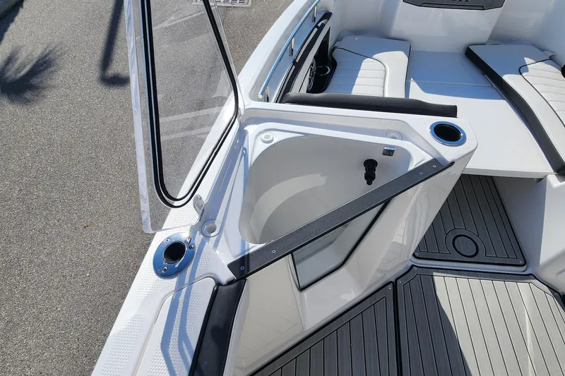 Slide: The Image of 2022 Yamaha 255 FSH Sport E boat interior with seating and storage compartment. - 22
